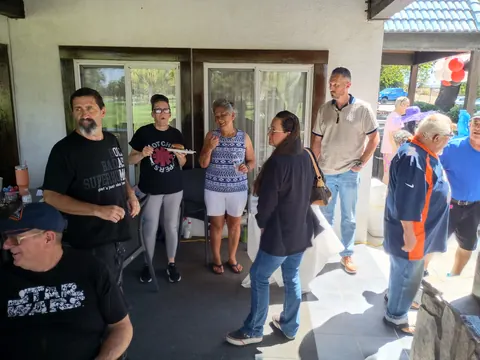 Guests standing and chatting near the patio entrance.